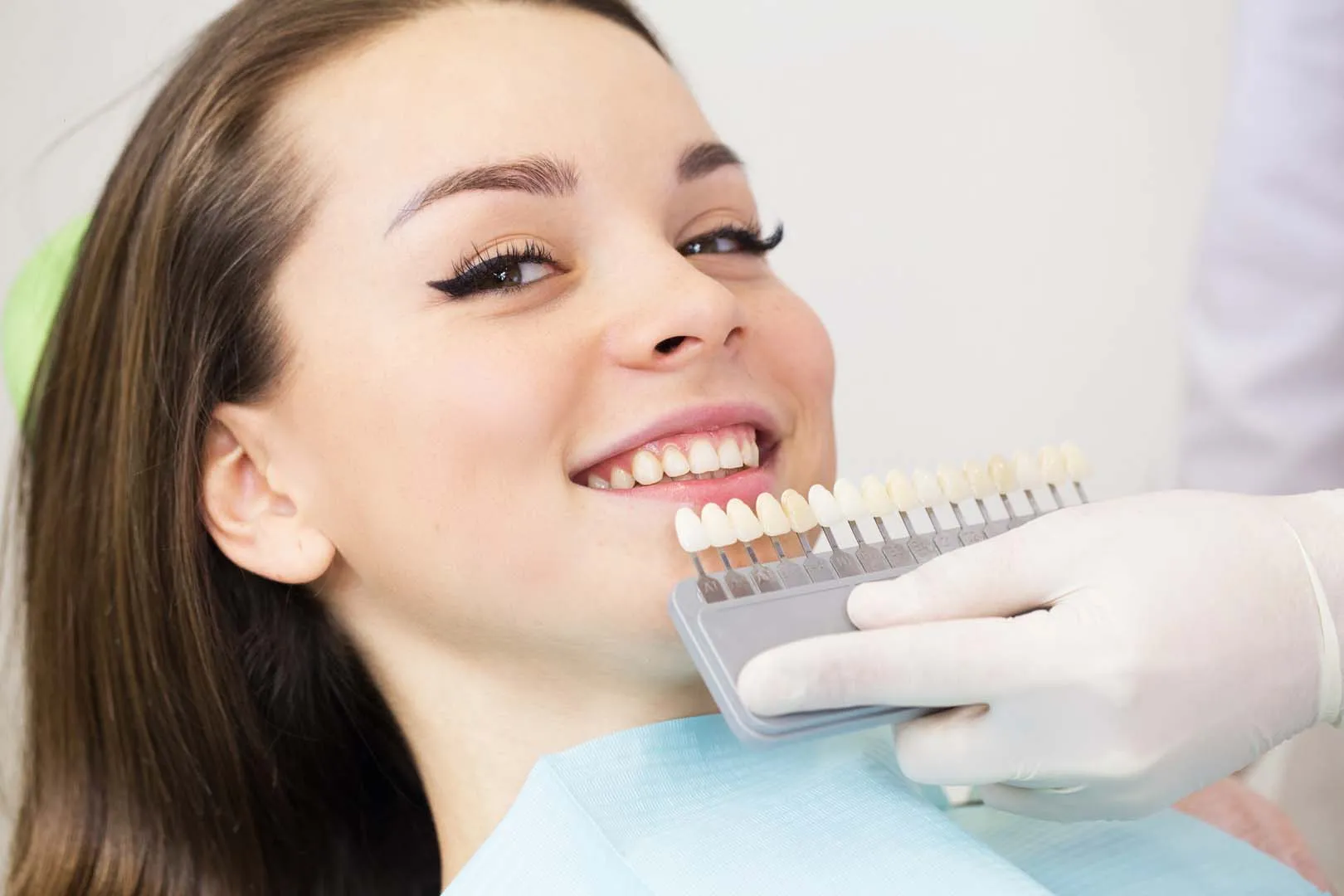 Patient with a confident smile after porcelain veneer treatment at Lucas Elite Dental Studio in Lucas, TX